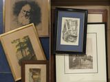 a box full of framed pictures and pictures on the floor