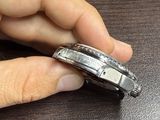 a person that is holding a watch in their hand