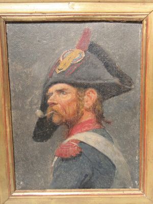 tableau représentant un homme avec une pipe à la bouche, dans un cadre doré