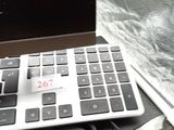 a computer keyboard and a laptop on a desk