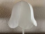 a white lamp that is on top of a table