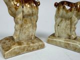 two figurines of a horse that are on a table
