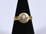 a close up of a gold ring with a skull on it