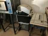 two microwaves and a toaster sitting next to each other in a room