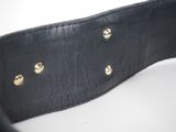 a close up of a black leather belt on a white surface