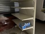a dirty shelf in the middle of a dirty room