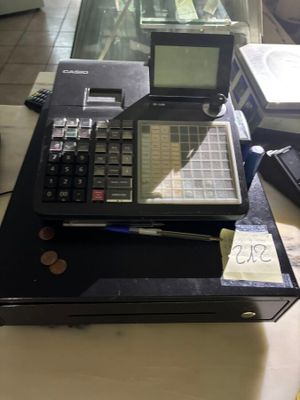 a calculator sitting on top of a table next to a stack of books