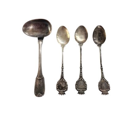 five spoons that are lined up on a white surface