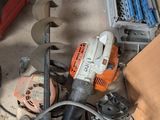 a picture of a man working on a machine in a garage