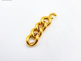 a close up of a gold chain on a white surface