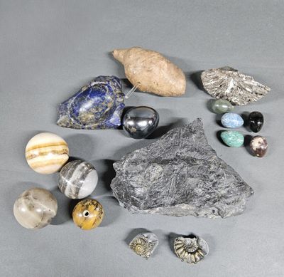 several different types of rocks and stones on a gray surface