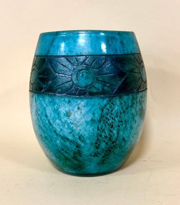 a blue vase sitting on a table with a white background