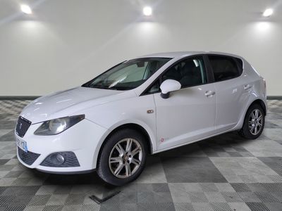 the white car is parked on a checkered floor in the garage