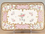 an ornately decorated tray with pink and green flowers on it