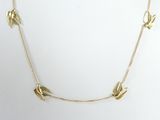 the necklace is made of gold metal and has birds on it
