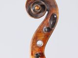 a close up of the back of a violin with a fiddle in the foreground