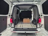 a white van with its doors open and a table in the back of it