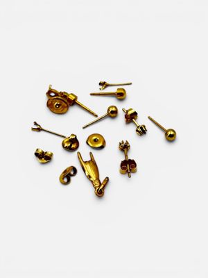 a close up of a bunch of gold colored screws on a white surface