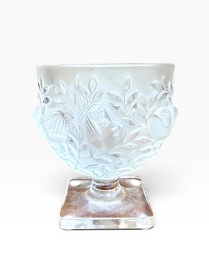 a white glass bowl with a silver base on a white background