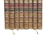 the old books are lined up in rows on a white surface