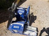 a small blue machine that is sitting on the ground