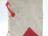 a white and red book with a red triangle on it