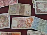 many different bank notes laid out on a table