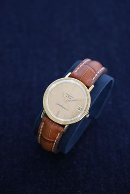 an image of a watch on a blue surface with a black background