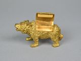 a gold bear figurine with a box on it