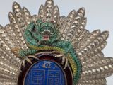 a dragon on top of a badge with a blue background
