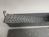 an old metal box with holes and a handle on top of it