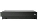 une console Xbox noire posée sur une surface blanche