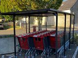 several shopping carts are lined up in a row in a parking lot