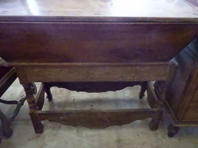 a wooden table with a drawer underneath it in a room