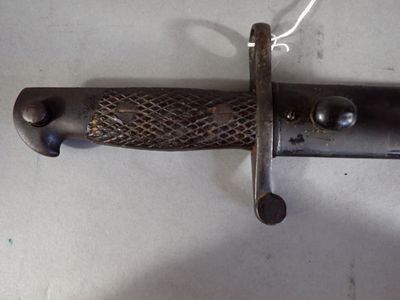 a close up of a knife hanging on a wall