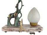 a statue of a horse on a stand next to a lamp