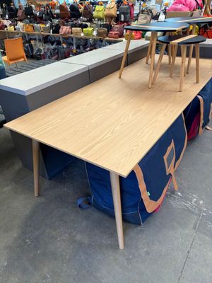 une longue table avec deux chaises posées dessus dans un magasin