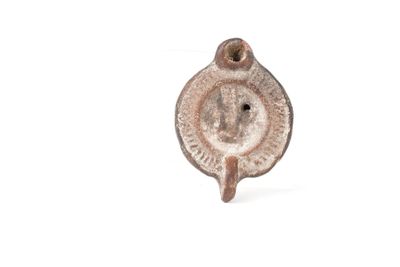 a small metal object with a face on it