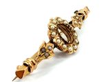 an image of a close up of a brooch with pearls on it