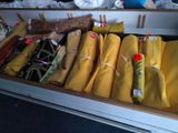 a drawer full of yellow fabric and other items