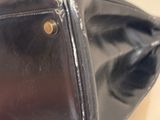 a black purse sitting on top of a stack of boxes