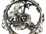 a bird nest in the middle of a silver plate