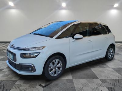 a white citrole is parked in a room with a checkered floor