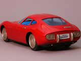 a red toy car that is sitting on a table