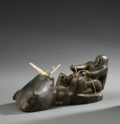 a sculpture of a person laying down with a knife in their hand
