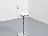 an image of a white plastic chair in a corner