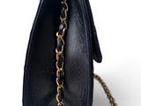 a close up of a black purse with a chain around it