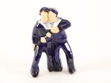 a small figurine of a man in a sailor ' s outfit