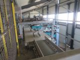 a picture of a factory with a conveyor belt in the middle of the room