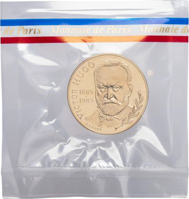 a close up of a coin in a plastic bag on a white background